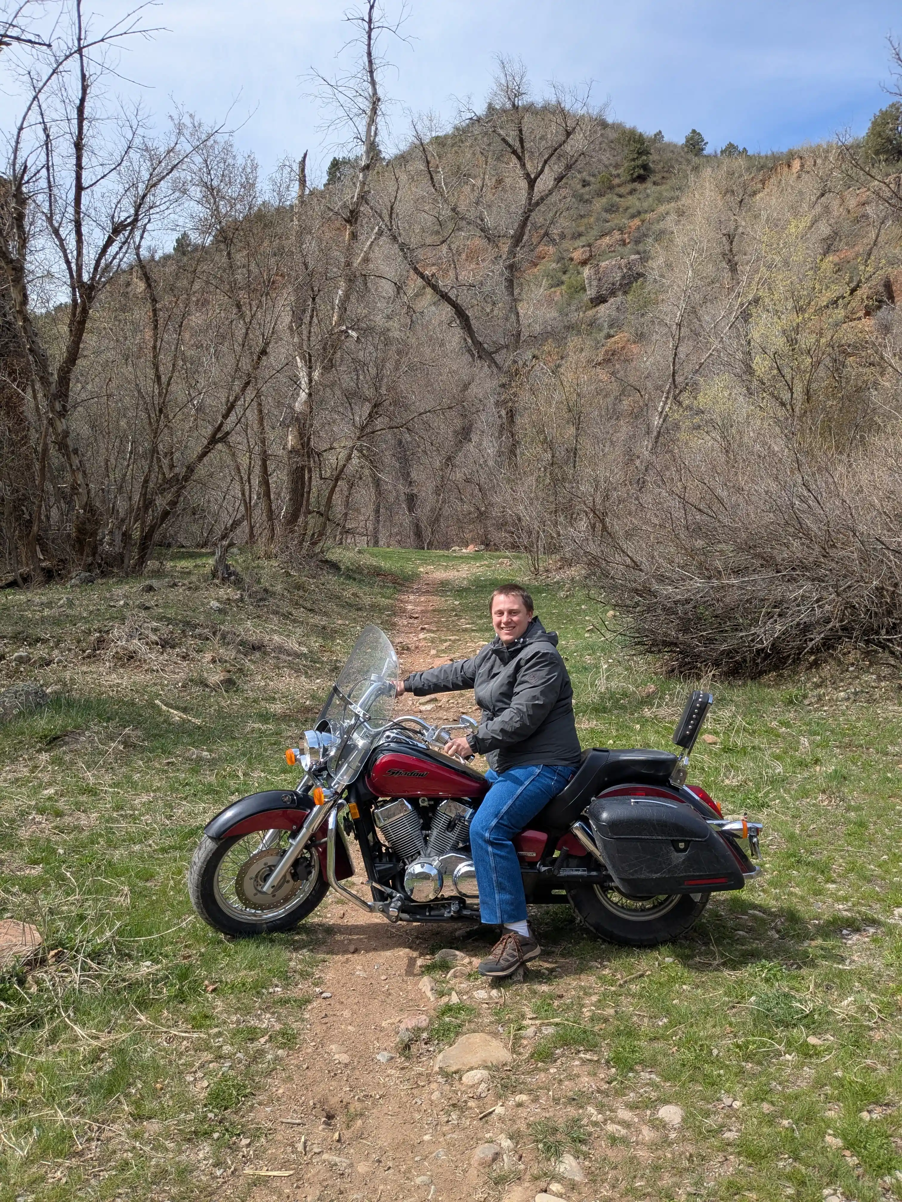A sick photo of me on my motorcycle on a dirt trail.
